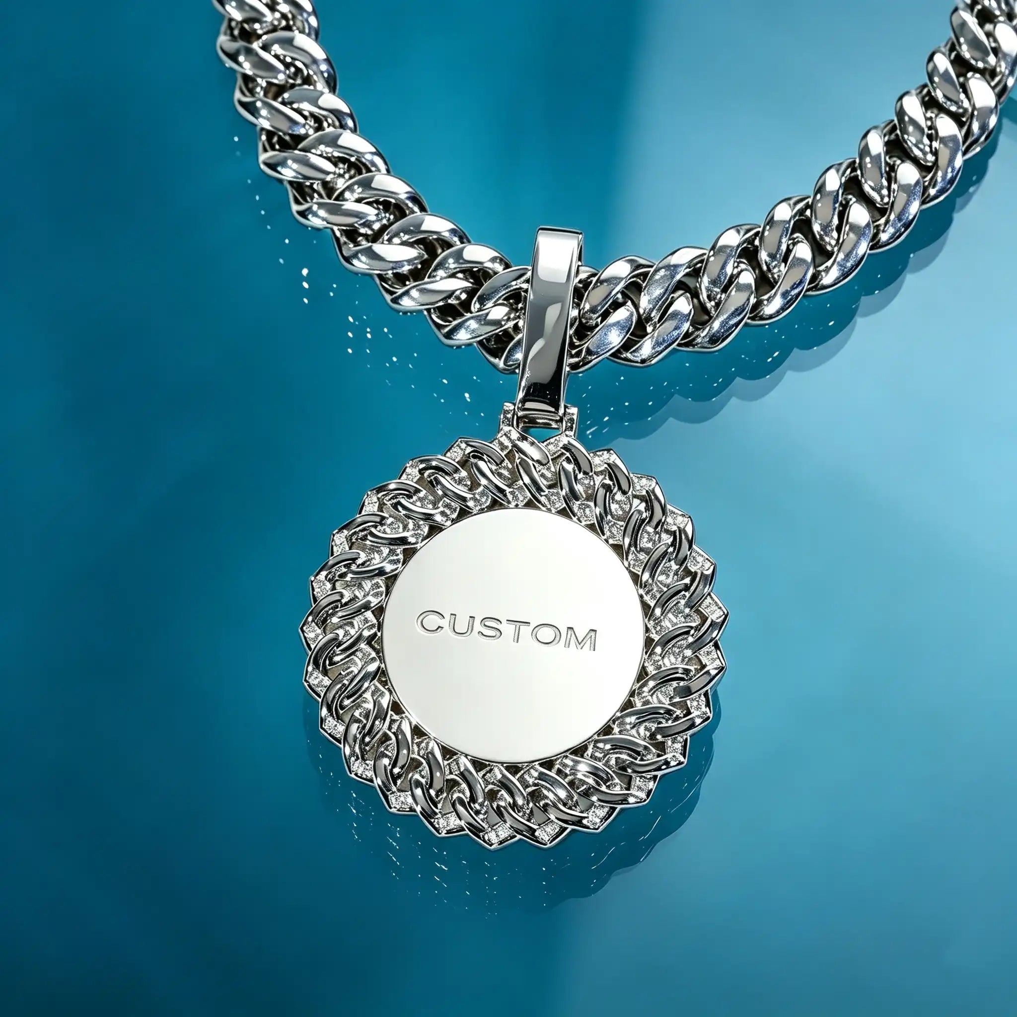 Large 3D Baguette Sunburst Custom Photo Pendant Necklace, silver tone pendant back view, sample engraved text "CUSTOM", custom personalized engraving available, matching cuban link chain, seamless blue transparent glass display surface, studio product shot, RDRIP JEWELRY
