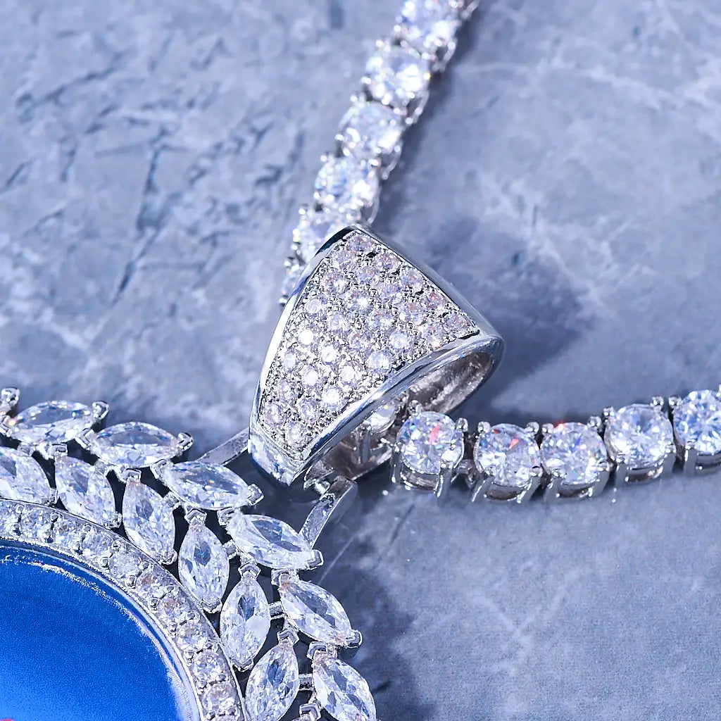 LARGE 3D DELUXE WHEAT EAR CUSTOM PICTURE PENDANT, macro close-up view of silver plated iced out stone-filled bail and multi-layer marquise wheat ear border, upgraded sunflower style custom photo medallion detail shot, matched with tennis chain on grey marble surface, RDRIP JEWELRY
