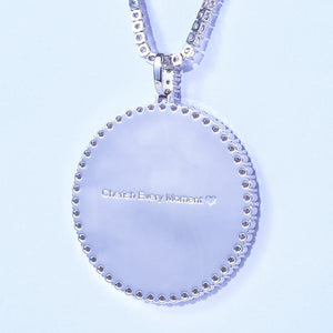VVS MOISSANITE LARGE 3D CIRCLE CUSTOM PICTURE PENDANT, close-up detail of pendant reverse side with customizable engraved text "Cherish Every Moment", silver iced out photo medallion hip hop necklace with tennis chain on pale light blue background, RDRIP JEWELRY
