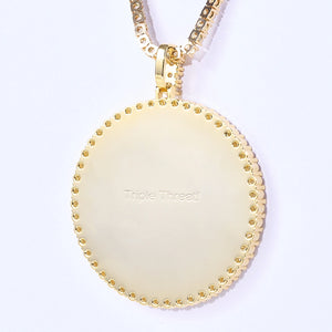 VVS MOISSANITE LARGE 3D CIRCLE CUSTOM PICTURE PENDANT, close-up shot of gold pendant reverse side featuring customizable engraved wording "Triple Threat!", iced out personalized photo medallion hip hop necklace matched with tennis chain on clean white background, RDRIP JEWELRY
