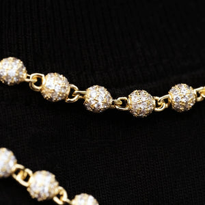 Extreme macro detail shot of RDRIP 4mm Iced Stellar Ball Bead Chain, 18K gold plated hip hop men necklace, close view of bead link construction and fully encrusted flawless VVS simulated diamonds on round sphere beads, shot against black fabric background, show fine metal craftsmanship and brilliant sparkle, premium iced‑out streetwear jewelry, RDRIP JEWELRY SINCE 2016
