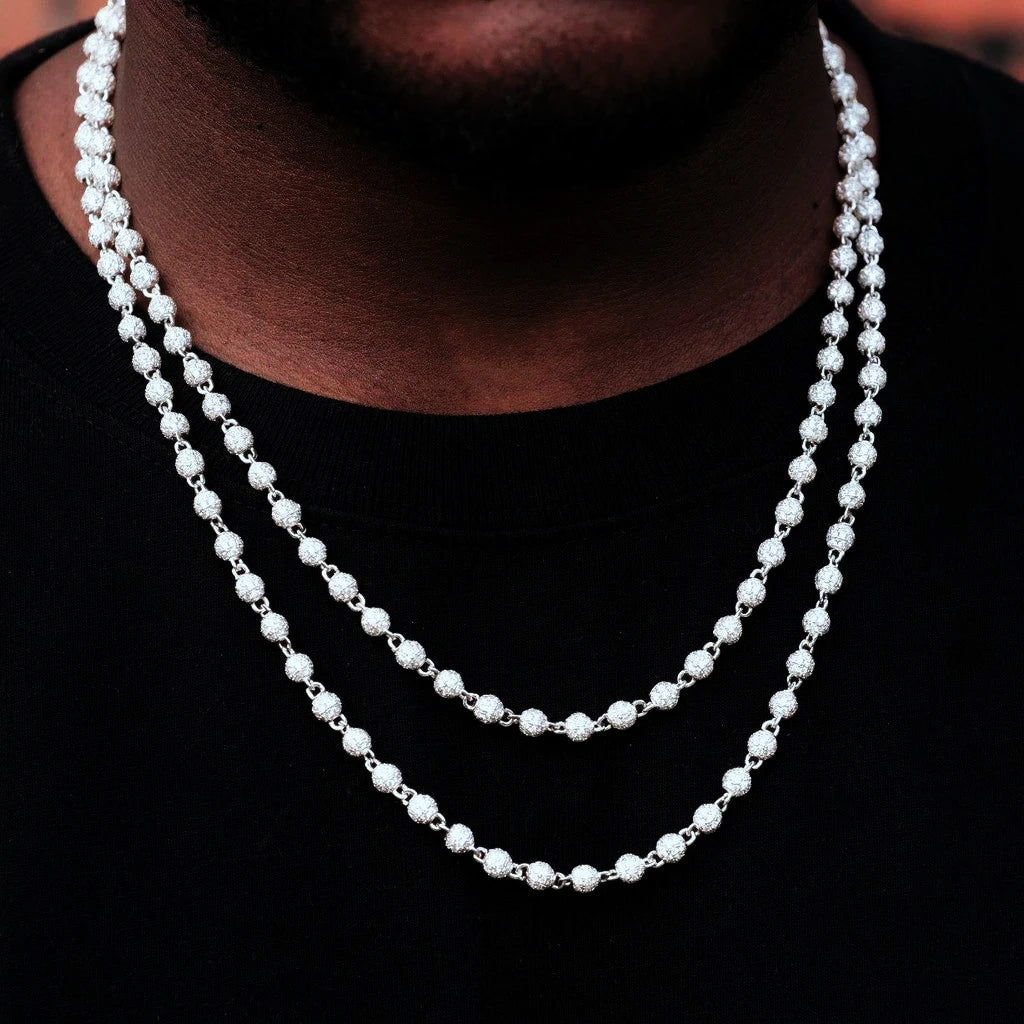 Real wearing shot of double layered RDRIP 4mm Iced Stellar Ball Bead Chain, white gold plated men hip hop necklace, fully paved flawless VVS simulated diamonds round ball bead link chain, silver tone layered necklace styling on male model with black crew neck top, bright sparkling iced‑out street fashion jewelry, RDRIP JEWELRY SINCE 2016
