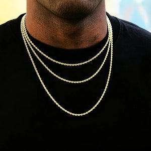 Short thick short beard Black male model wearing three different lengths 2mm 18k gold plated twisted rope chain layered stack necklace, slim dainty twist link hip hop men jewelry, classic unisex layering staple chain, smooth soft pale yellow and light blue gradient solid background, minimalist streetwear rap accessory, can match custom pendant, handcrafted gold rope necklace RDRIP JEWELRY SINCE 2016
