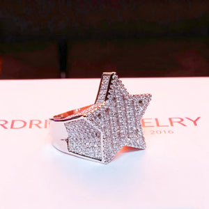 Side profile angled view of men’s heavy 3D micro‑pave pentagram star iced out ring, silver‑toned 18k gold plated finish, hand‑set mixed baguette and round cut AAA cubic zirconia stones, bulky hip‑hop rapper statement ring, displayed on branded RDRIP JEWELRY paper backdrop, urban fashion bling men jewelry, RDRIP JEWELRY
