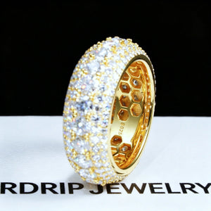 Side profile close‑up shot of men’s 9mm wide iced‑out multi‑layer full pave moissanite eternity band RDRIP JEWELRY SINCE 2016, 18K gold plated solid 925 sterling silver ring hand‑set with D‑Color VVS1 4mm hearts and arrows round moissanite stones, inner honeycomb hollow construction with S925 stamp, ring placed on branded RDRIP JEWELRY white paper surface against dark black background, premium hip‑hop bling men’s statement jewelry

