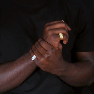 Real wear pose of stacked baguette iced out hip hop rings, gold tone and silver tone wide band men rapper rings displayed on model hands, street fashion bling jewelry lifestyle shot RDRIP JEWELRY
