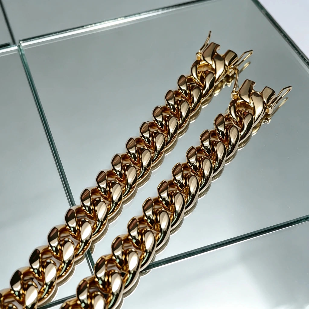 Close up top down shot of two matching polished heavy 12mm 18k gold plated classic Miami cuban link bracelets for men solid stainless steel base with triple thick IP gold wrapping full gold coverage inside every chain link fully open triple safety lock box clasp bright reflective golden metallic finish heavyweight 106g hip hop streetwear stacking wrist jewelry tarnish fade resistant durable daily wear mens rapper bling accessory budget friendly alternative to costly real solid 18k gold cuban bracelets 