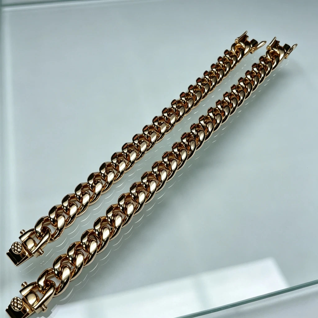 Top down comparison shot of two polished heavy 12mm 18k gold plated classic Miami cuban link bracelets for men made of solid stainless steel with triple thick IP gold coating full gold coverage inside every chain link premium triple safety lock box clasp shiny reflective golden finish weighty 106 gram hip hop rapper stacking wrist jewelry tarnish and fade resistant daily wear mens bling accessory budget friendly alternative to expensive real solid 18k gold cuban bracelets available in 7 inch and 8 inch wris