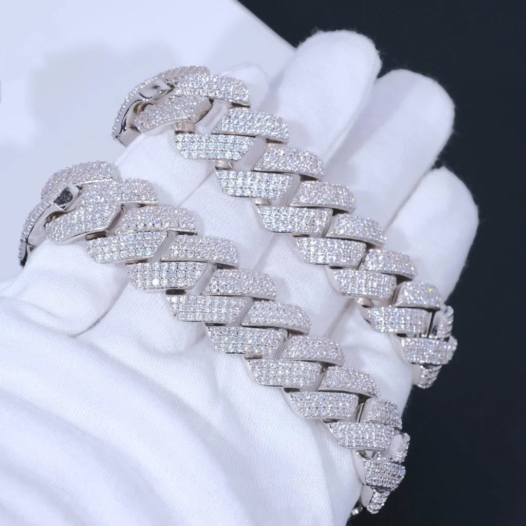 Overhead studio shot of two identical 19mm full iced out prong cuban link bracelets laid neatly on soft white cotton jewelry gloves, every cuban link fully encrusted with flawless lab-tested VVS simulated diamonds secured by precise hand prong setting, premium 18K white gold plating over solid copper core, oversized wide heavy hip hop bling wrist chains with dazzling icy sparkle, unisex luxury streetwear jewelry scratch and tarnish resistant for men and women RDRIP JEWELRY

