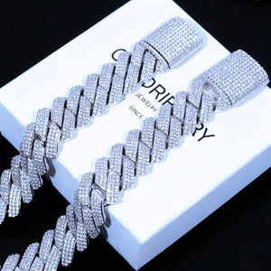 Flat lay studio product shot featuring two 19mm wide full iced out prong cuban link bracelets resting on branded RDRIP JEWELRY gift box printed with SINCE 2016, every cuban link and large box clasp fully covered with flawless lab tested VVS simulated diamonds set by skilled hand prong lifting craftsmanship, solid copper base coated with premium shiny 18K white gold plating, heavy oversized unisex hip hop bling wrist jewelry with brilliant icy reflective shine, tarnish and scratch resistant luxury streetwear
