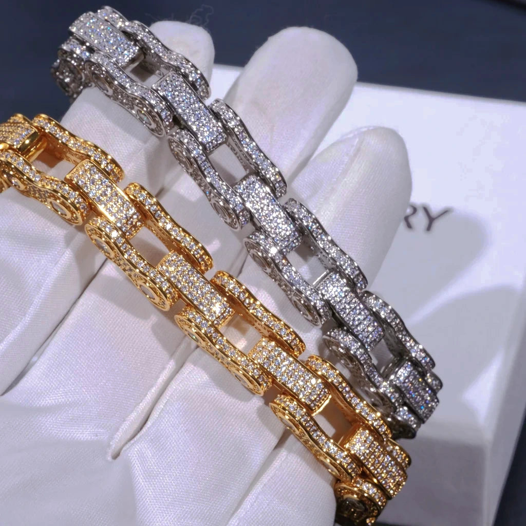 11mm full iced out bike chain link bracelet dual color close-up side profile shot, 18k gold plated and white gold plated motorcycle biker wrist jewelry fully covered flawless VVS simulated diamonds, hand set stones without glue with intense bling shine, two bracelets held side by side on soft white cotton glove with RDRIP JEWELRY brand box background, heavy drip hip hop streetwear statement accessory for men available in 7 inch and 8 inch sizes premium fashion men jewelry gift RDRIP JEWELRY
