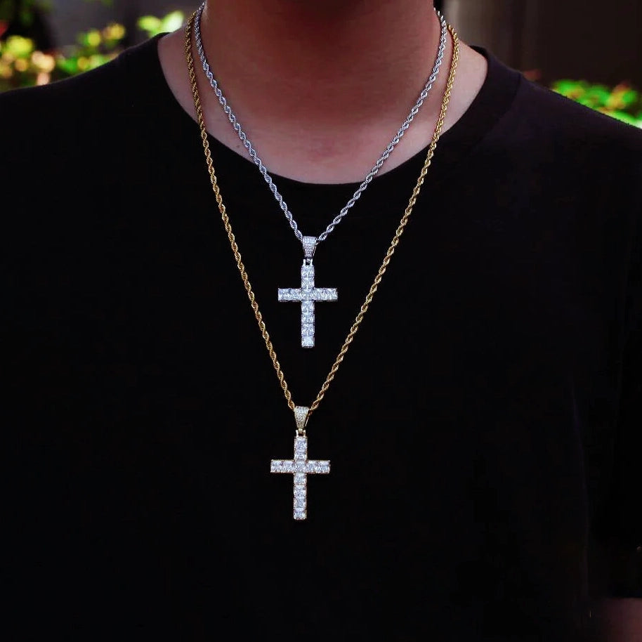 Men outdoor lifestyle shot with two layered baguette iced cross pendants, white gold silver cross on rope chain stacked with gold tone cross necklace, dual tone hip hop religious street jewelry worn on black t‑shirt RDRIP JEWELRY
