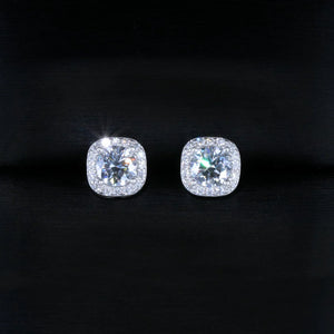 VVS1 Moissanite 7MM Cushion Halo Stud Earrings, 925 sterling silver white gold plated screw‑back earrings for men, round center moissanite stone with pave cushion halo frame, brilliant fire and sparkle, unisex iced‑out hip hop bling studs photographed on dark silk fabric background, RDRIP JEWELRY

