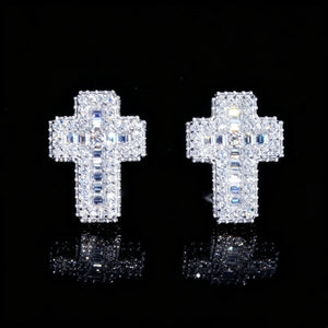 Close-up VVS1 Moissanite Baguette Cross Stud Earrings on reflective black jewelry display board, iced out full pave mixed baguette and round moissanite cross earrings, secure screw back setting, 925 sterling silver white gold plated unisex hip hop jewelry RDRIP JEWELRY