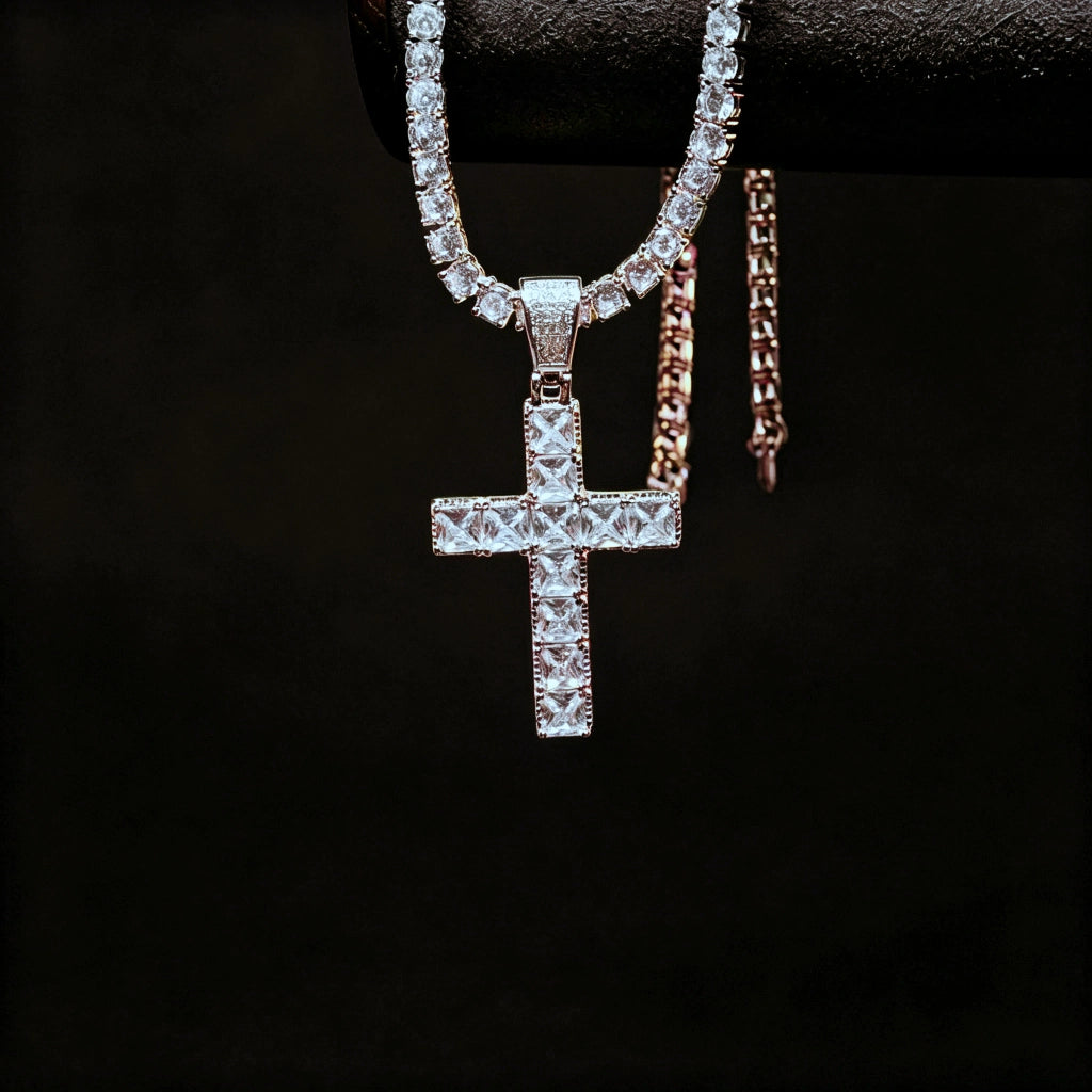 White gold plated baguette cut iced out cross pendant hanging display shot with tennis chain, flawless vvs simulated diamond hip hop necklace for men, hanging on jewelry stand with solid pure black background RDRIP JEWELRY
