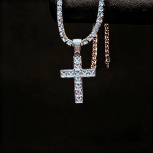 White gold plated baguette cut iced out cross pendant hanging display shot with tennis chain, flawless vvs simulated diamond hip hop necklace for men, hanging on jewelry stand with solid pure black background RDRIP JEWELRY
