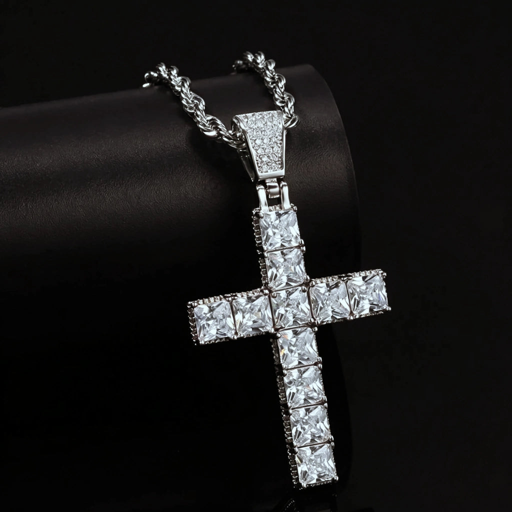 White gold plated baguette cut iced out cross pendant close up studio shot, set with vvs simulated diamonds, matched with stainless steel rope chain, bling hip hop religious necklace for men against dark black background RDRIP JEWELRY
