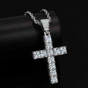 White gold plated baguette cut iced out cross pendant close up studio shot, set with vvs simulated diamonds, matched with stainless steel rope chain, bling hip hop religious necklace for men against dark black background RDRIP JEWELRY
